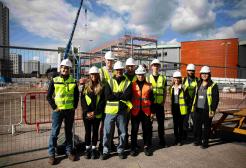 A group in front of a building site 