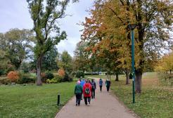 People walking through Peel Park in autumn.