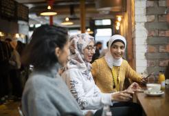 Three students in Mackie Mayor market, Manchester