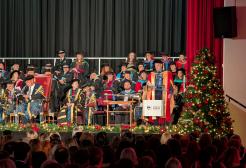 Academics sitting on stage during a graduation ceremony