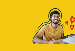 A student holding a pen sits at a desk with an open book in front of him. His background is a yellow swatch with three cartoon hearts.