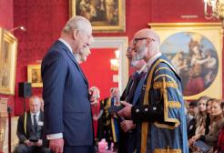 Professor Nic Beech and Professor Will Swan receive an award from The King and Queen