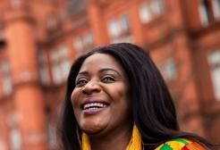Alumni volunteer smiling outside Peel Building, University of Salford