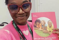 Victory is pictured holding up a copy of the course materials