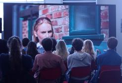 Students watching a film on a cinema screen 