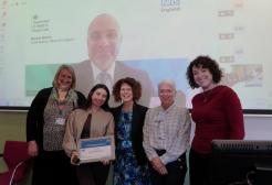 Gabby is pictured receiving her awards alongside her employer, representatives from the University and NHS England