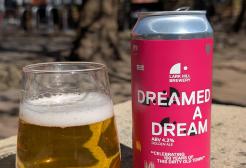 A beer glass alongside a can of Dreamed a Dream, a golden ale brewed by Lark Hill Brewery