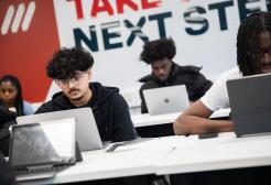 Students with laptops engaged in self-directed study