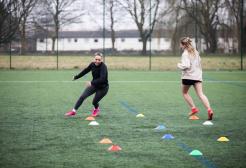 Two Students Running Around 3G Pitch