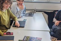 Students and academic sat around table