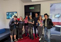 Group of creative digital media and gaming students standing together