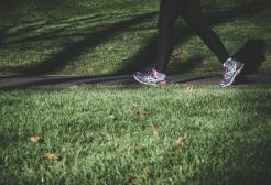 Feet walking along a path through grass