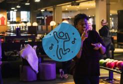 A student bowling with a dance sticker