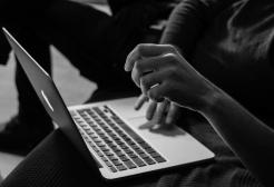 Person using a laptop computer, illustrating online activity, cybersecurity awareness and safe use of digital technology.