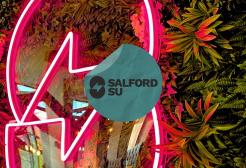 Salford SU logo as a neon sign with an SU sticker