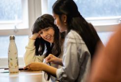 Two people studying together in a classroom setting