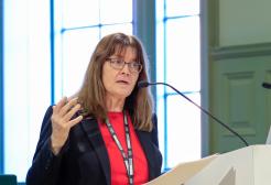 Professor Helen Marshall OBE speaking at a podium