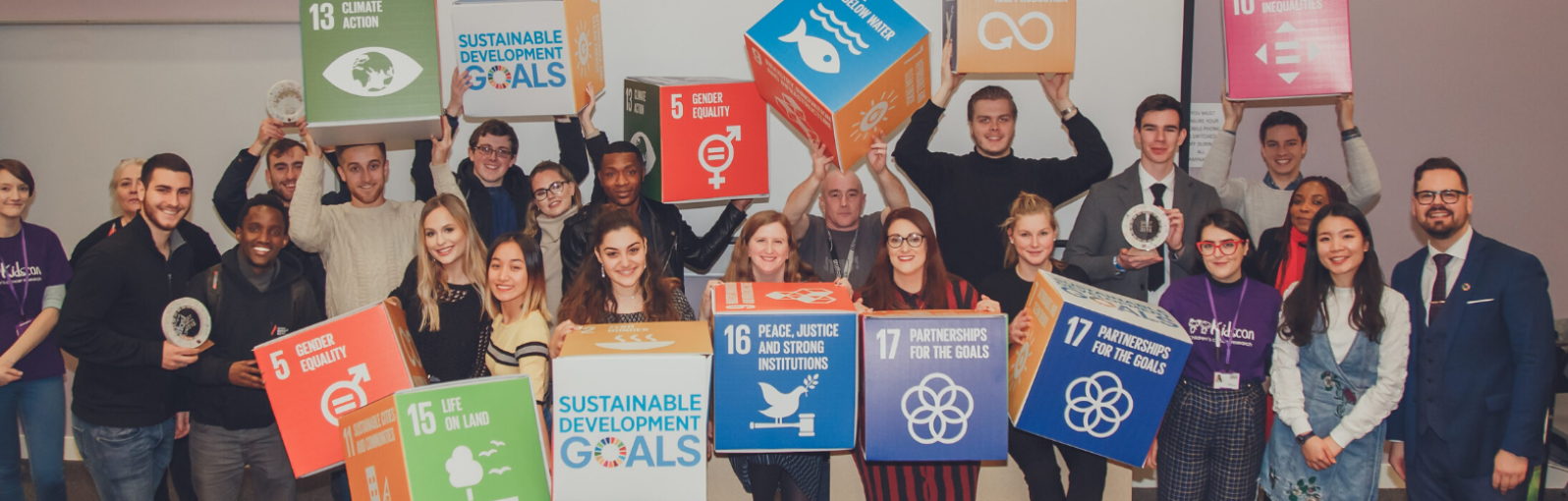 group of students holding Sustainable Development Goals cubes