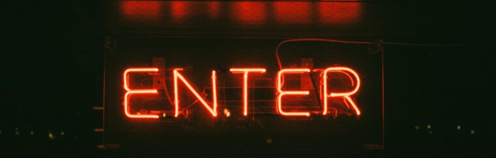 A neon sign showing the word 'ENTER'