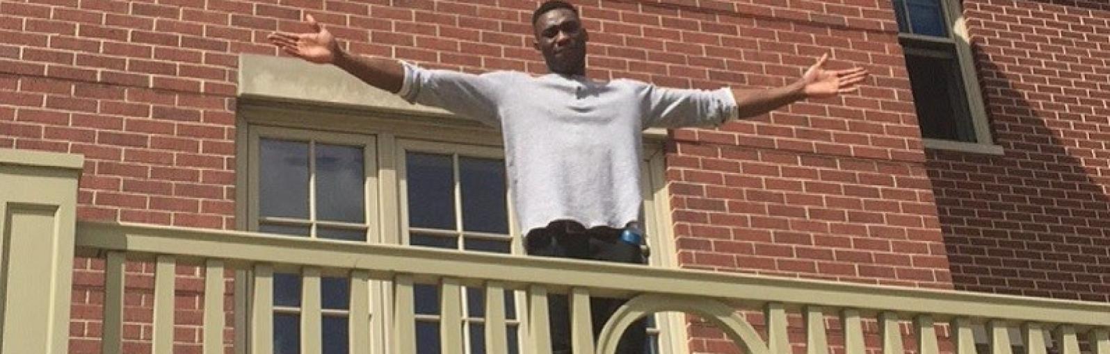 Emmanuel Adebayo on balcony in US
