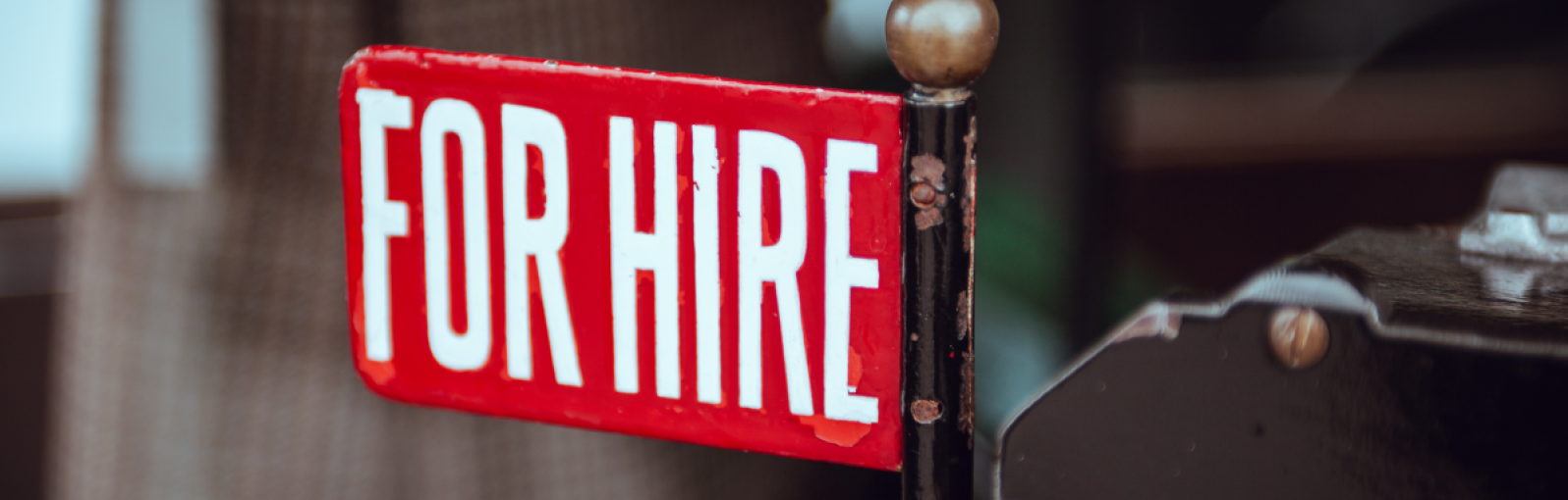 A sign shows the word 'hire'