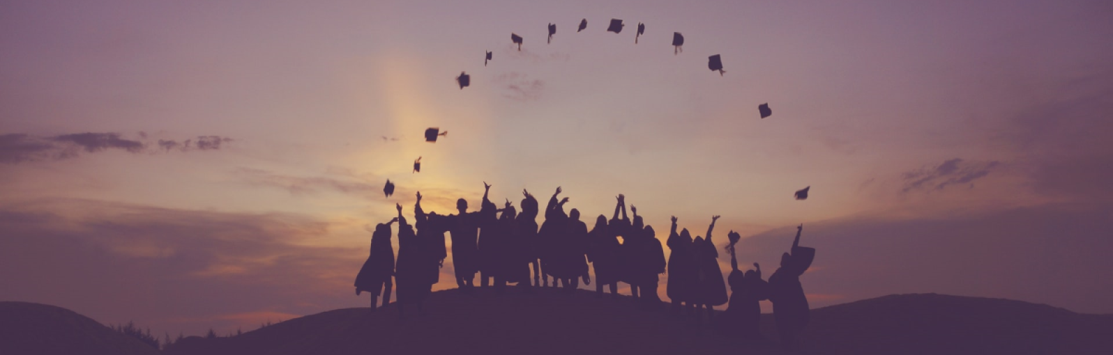 Graduates throw their hats into the air
