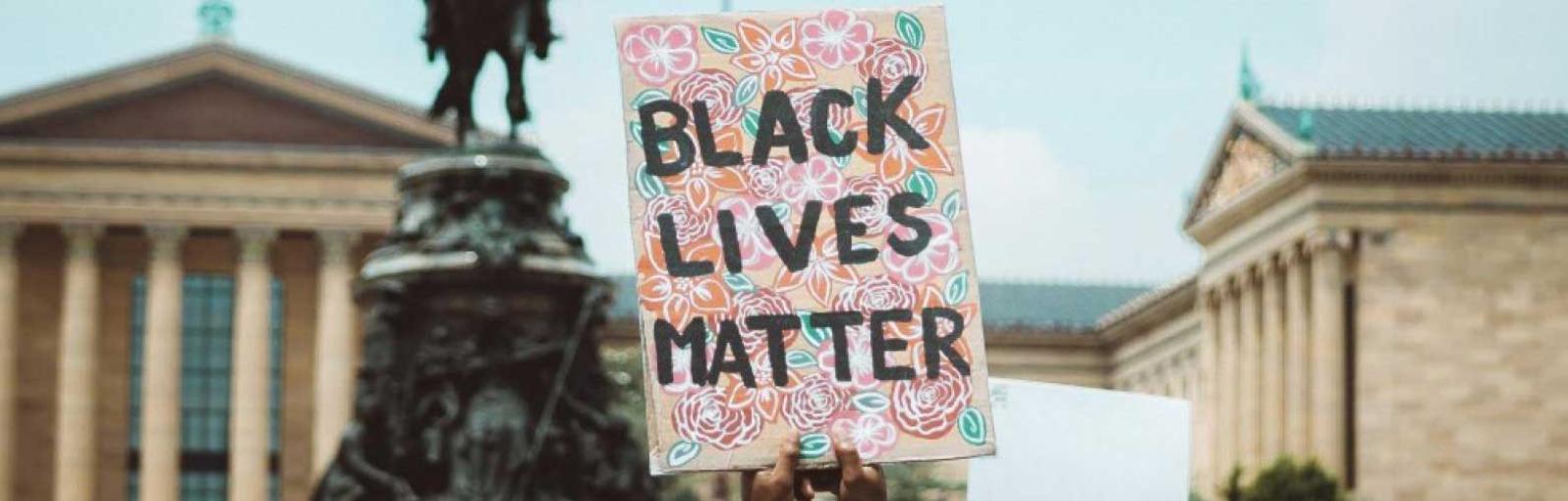 A protestor holds a placard bearing the Black Lives Matter slogan