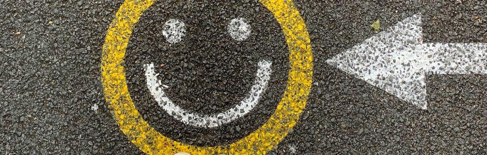A smiley face painted on tarmac