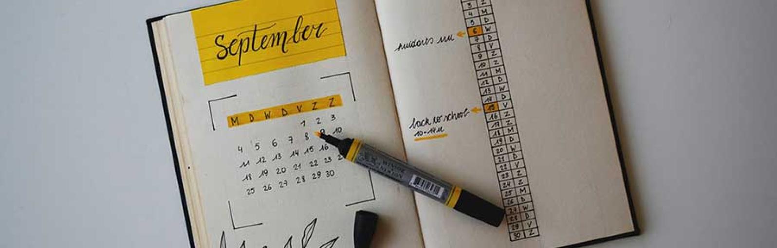 A planner book with a pen