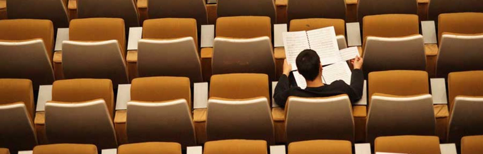 A person works in a lecture theatre