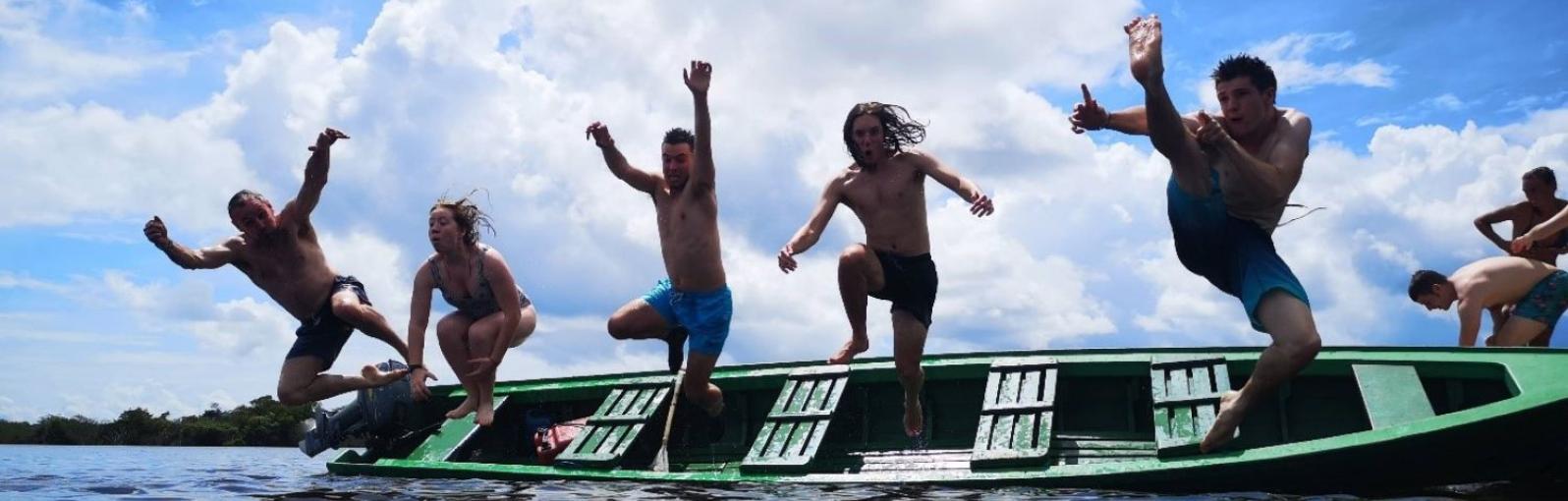 Students jumping off a boat during Brazil field trip 2020