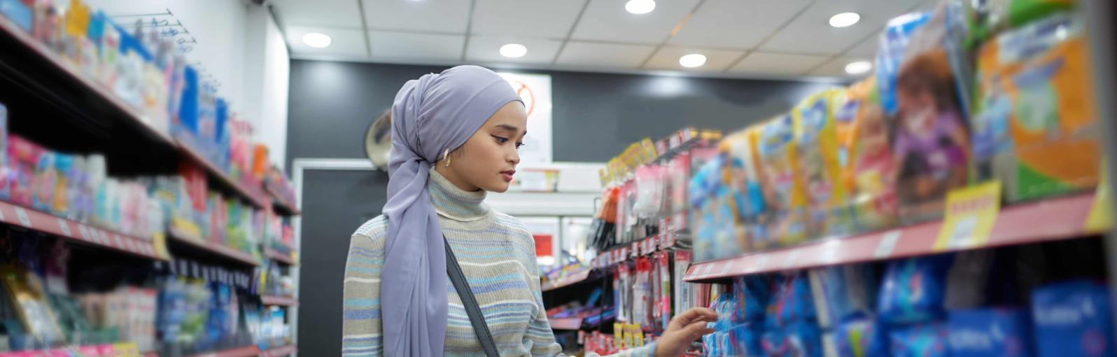 Student shopping in convenience store aisle