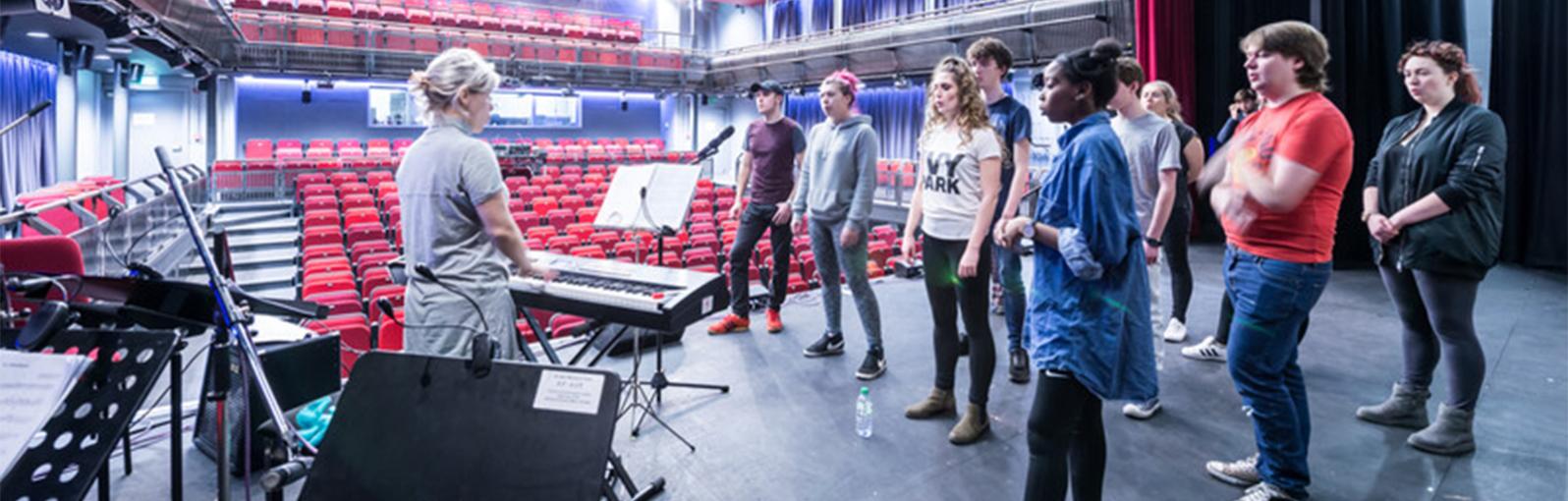 Students rehearsing in theatre