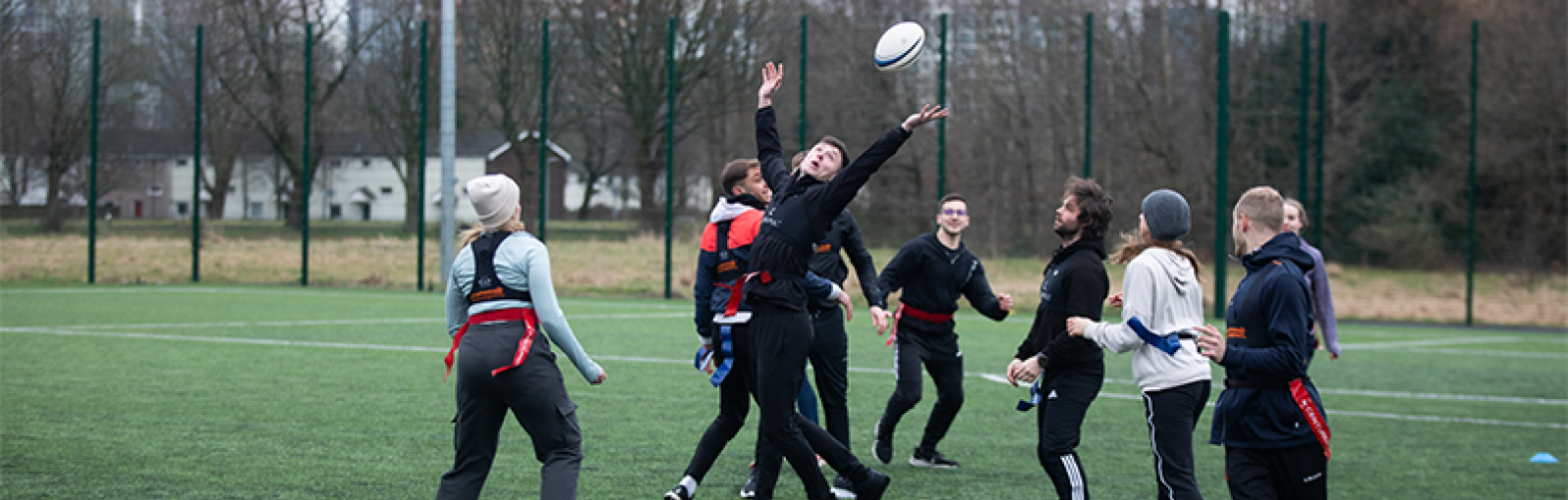 Students wearing GPS trackers and playing rugby