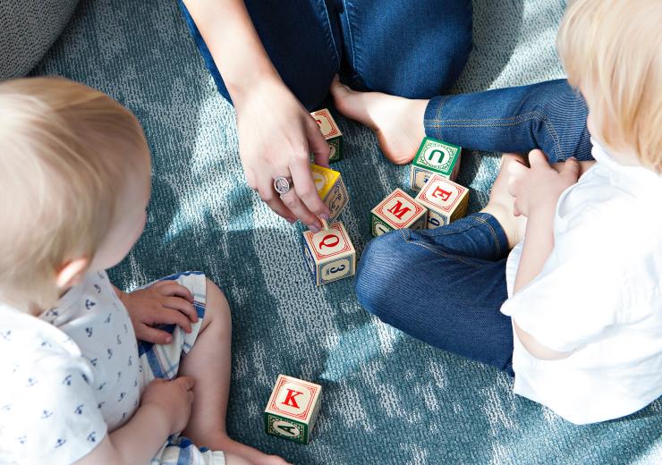 Two children playing with building blocks
