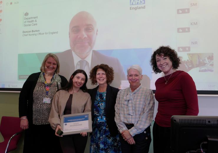 Gabby is pictured receiving her awards alongside her employer, representatives from the University and NHS England