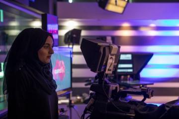 A female student operating a camera