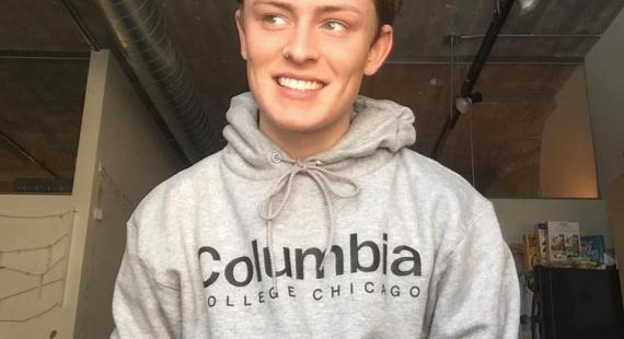 Male student wearing a grey Columbia College Chicago hoodie
