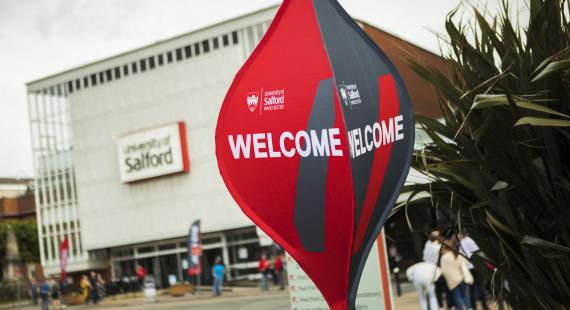 Welcome spinner signage at the University of Salford