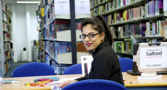 A student studies at a desk in the Library