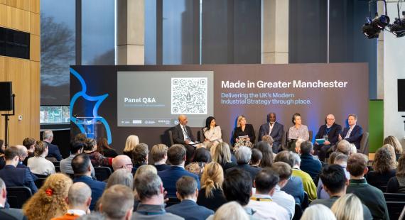 A panel discussion in front of an audience