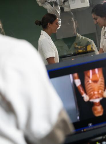 Students looking at medical scan image on screen