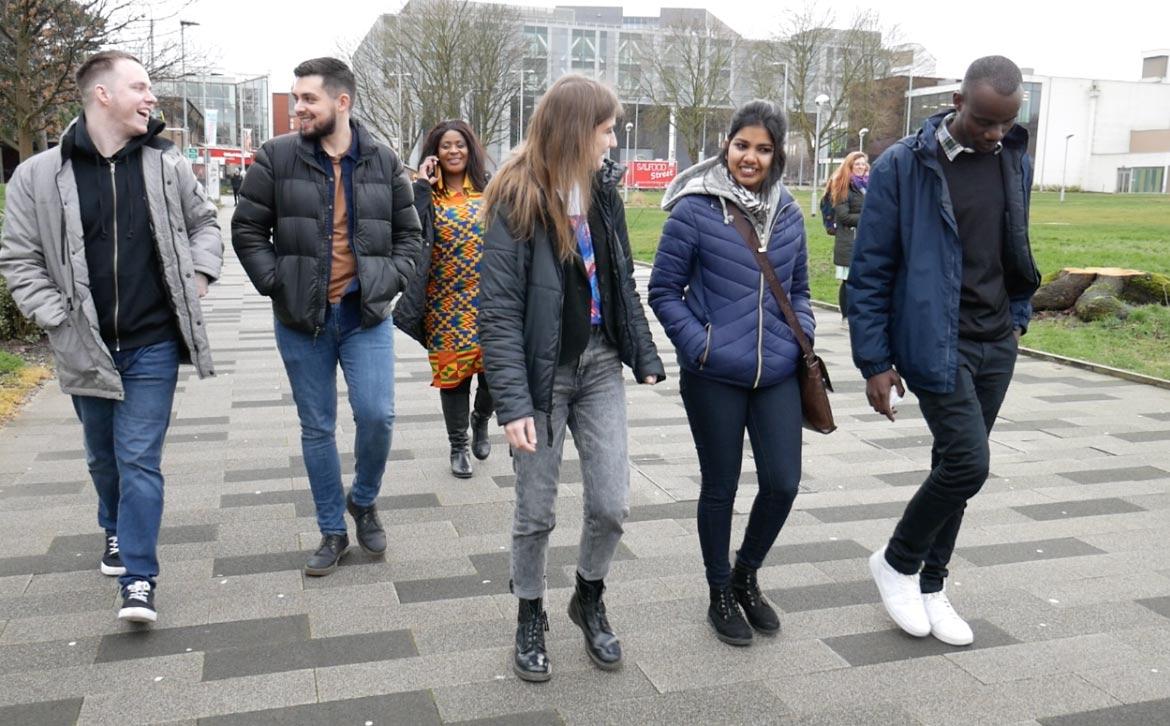 Six students walking through Peel Park Campus