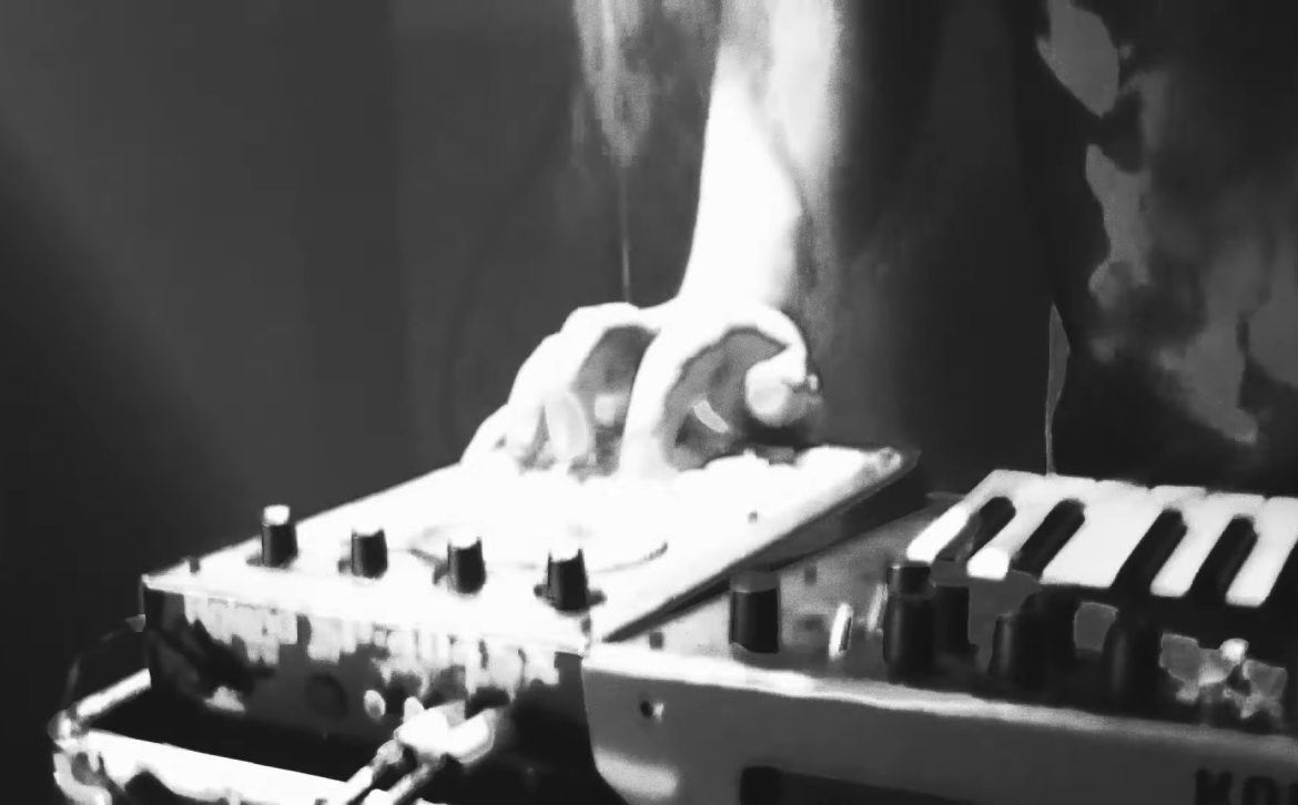 A hazy image of a man playing the keyboard