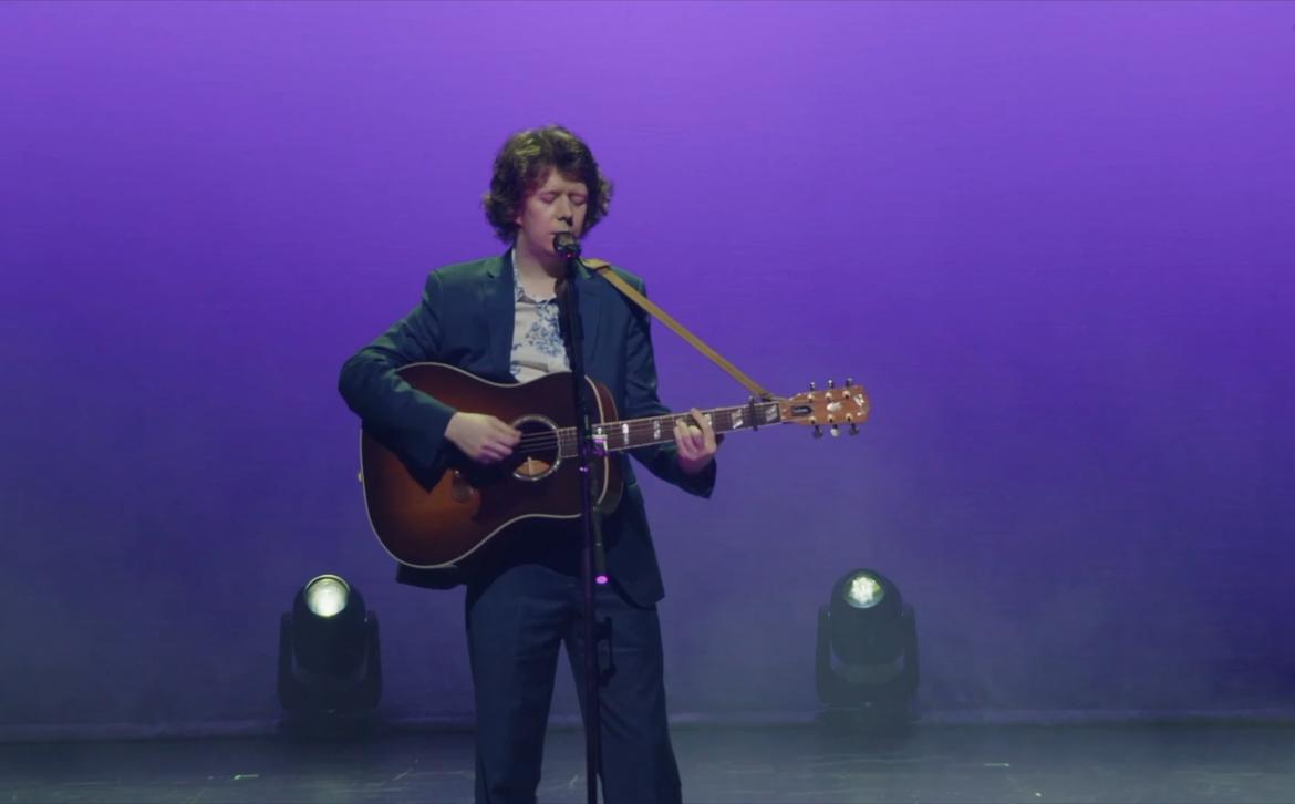 James Holt performing on stage at Univision