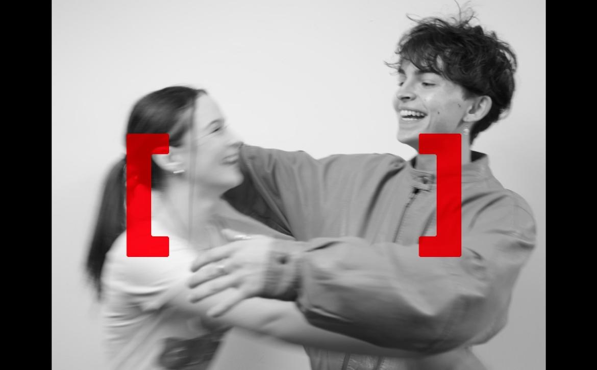 Two people hugging overlaid with the Power of Us square brackets motif