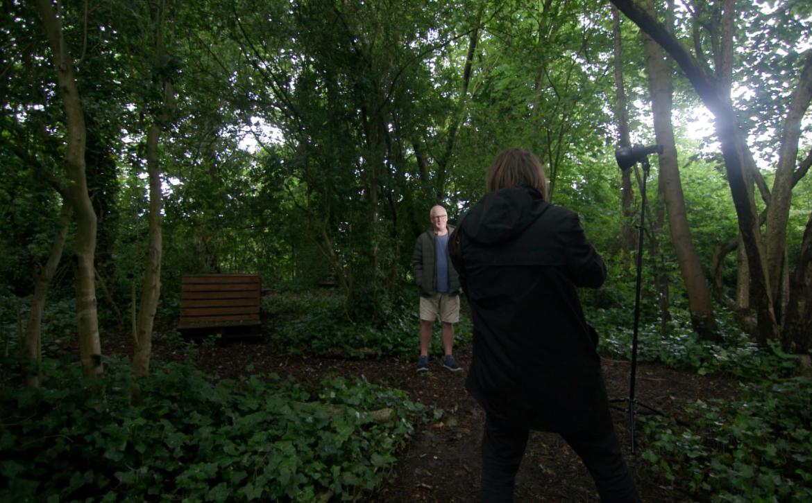A photographer taking a photograph of Ian Bocock at Cleavley Community Forest Garden