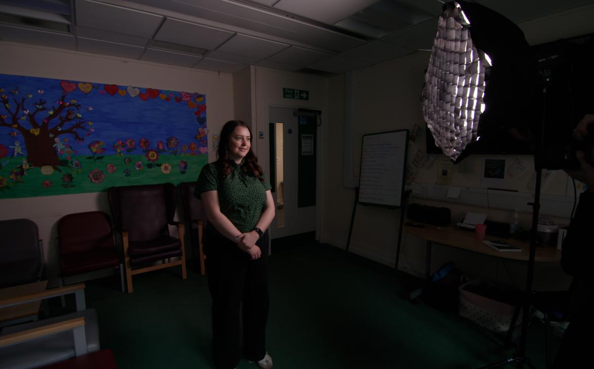 A photographer taking a photograph of Michelle Anderson at OPAL