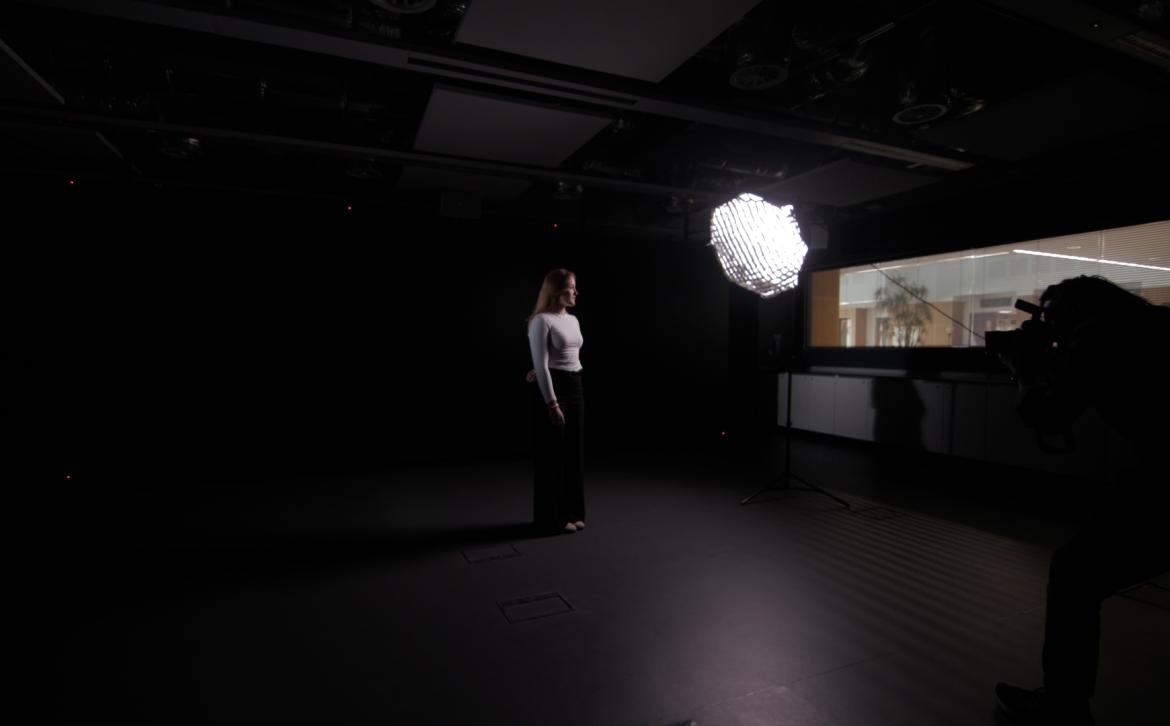 A photographer taking a photograph of Sri Hollema in a studio